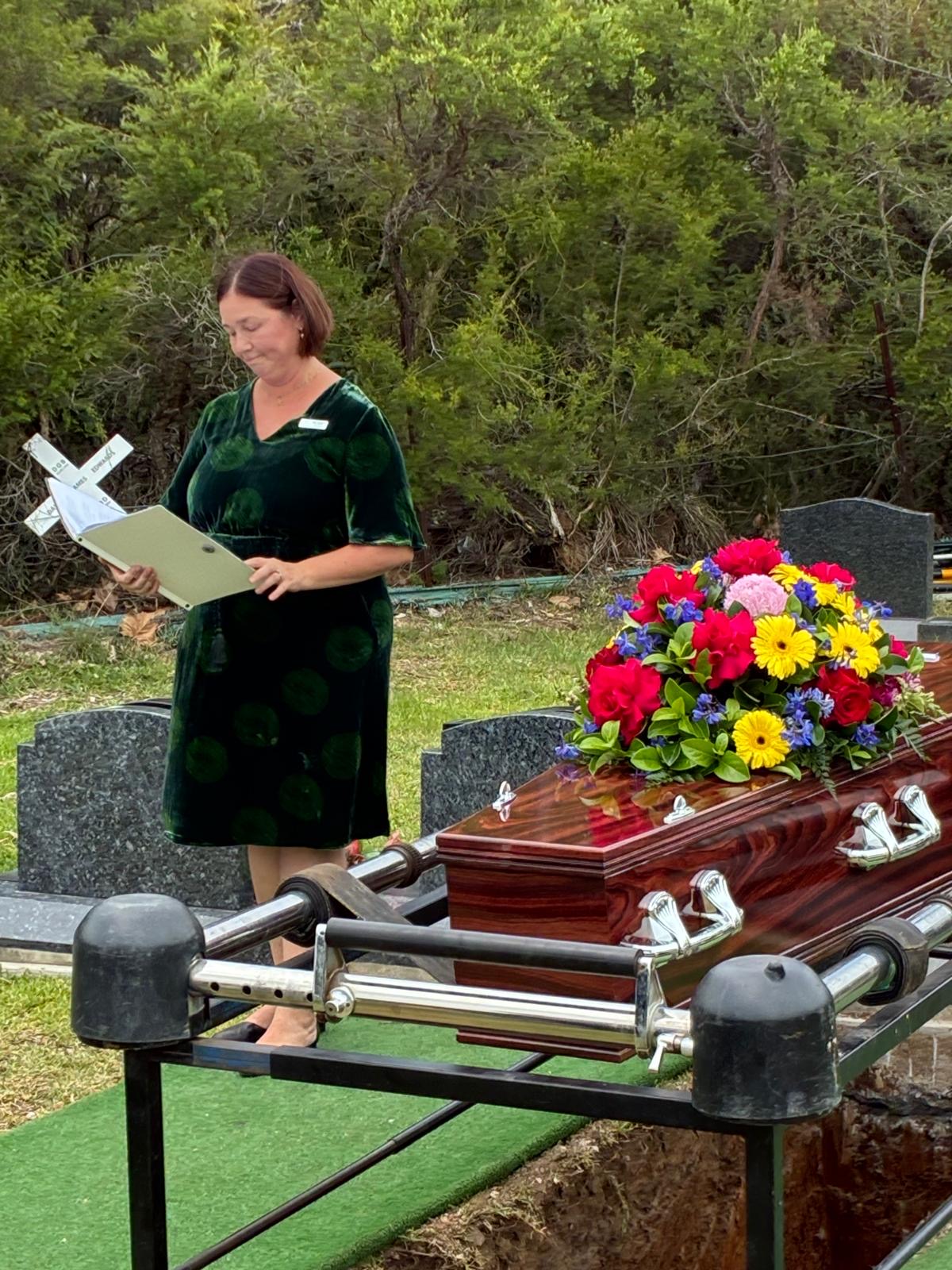 Graveside service coffin with flowers